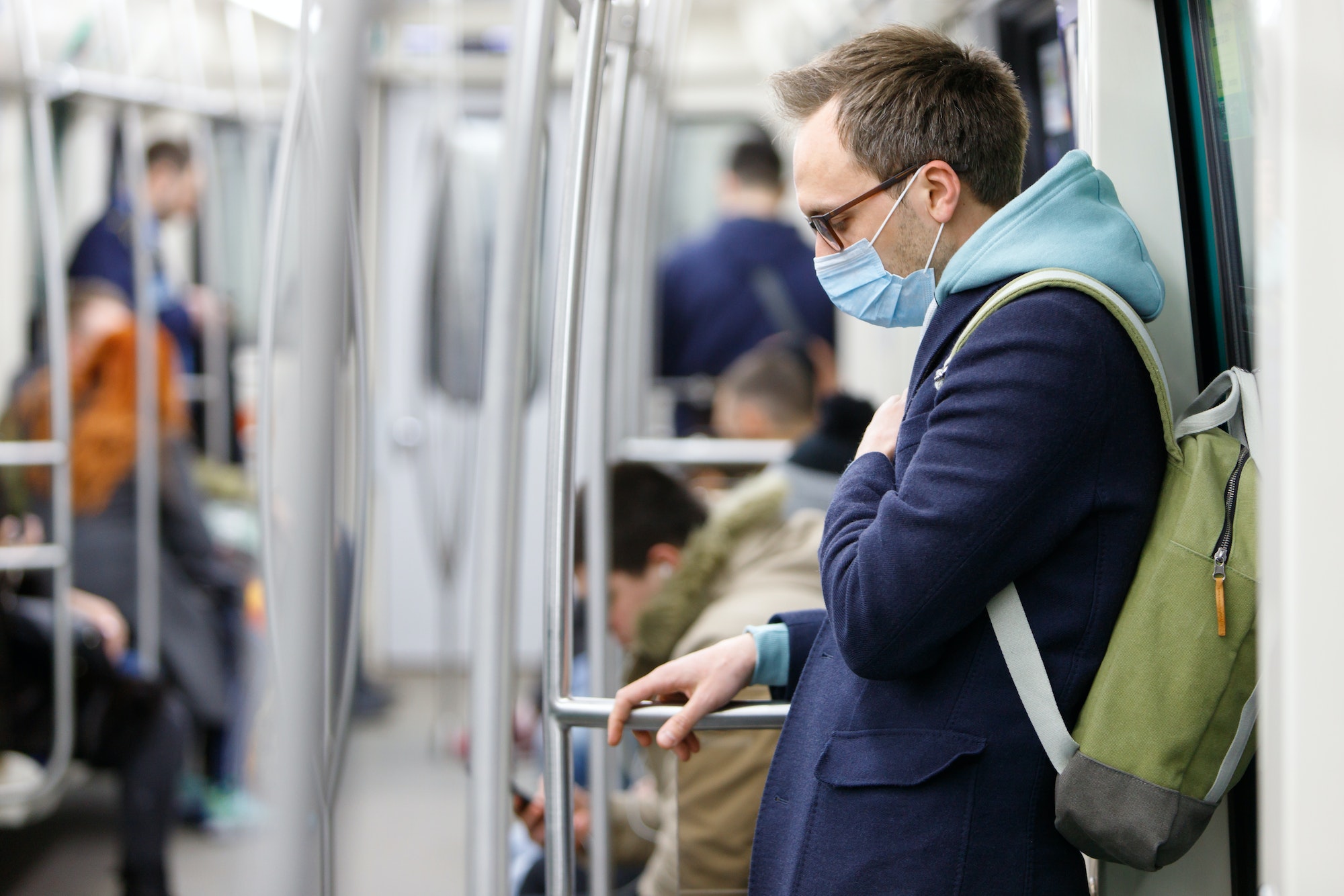 Sick man wear face protective mask in subway train during covid-19 corona pandemic.