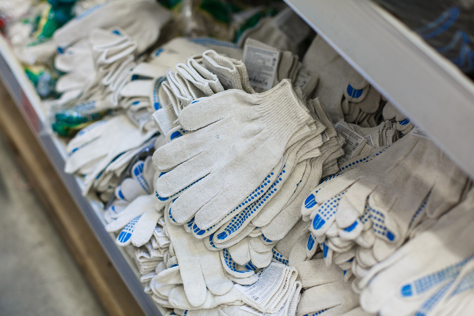 Working Protective gloves. A man in a hardware store buys gloves.