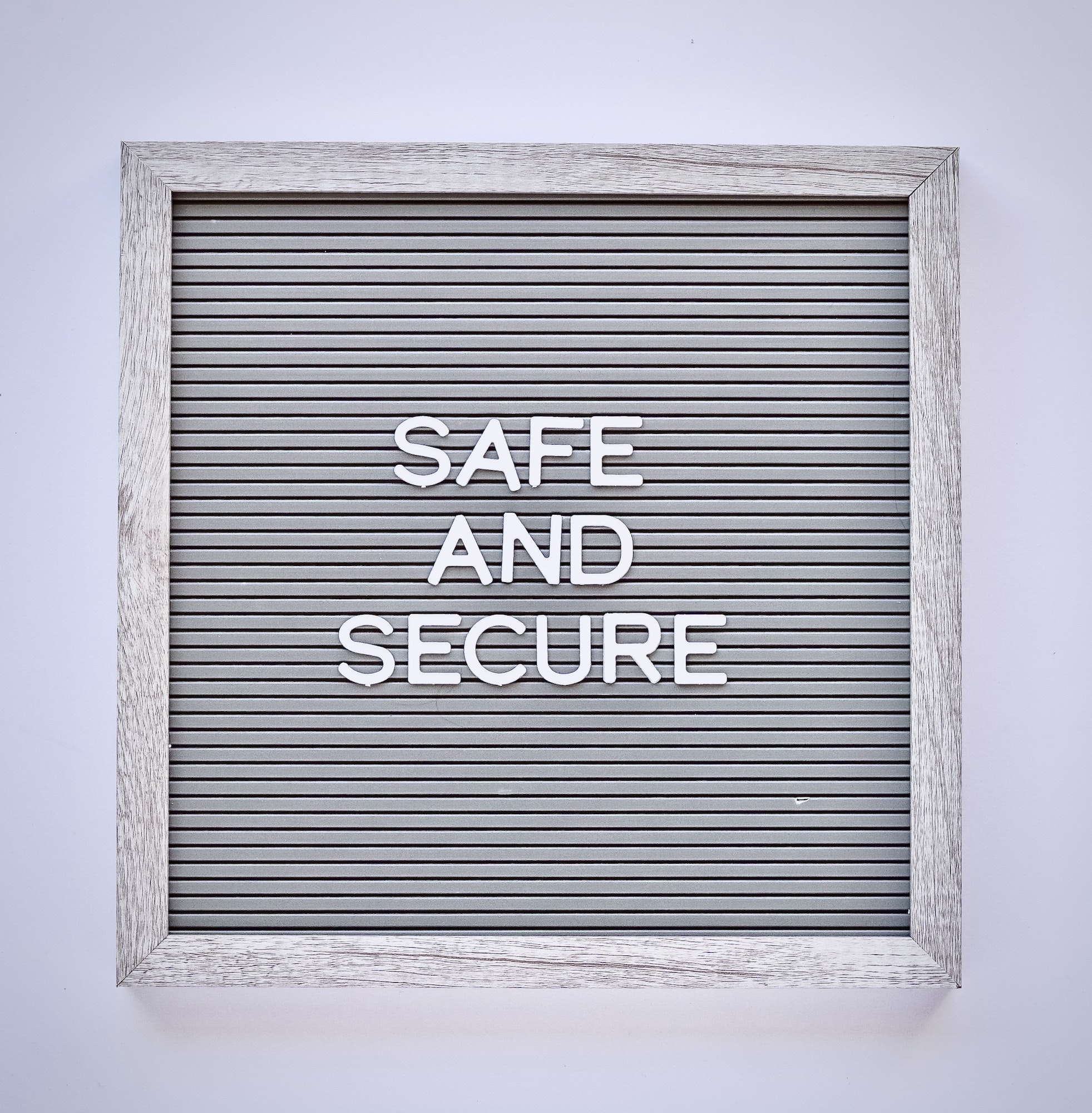 Overhead view of a letter board with text safe and secure