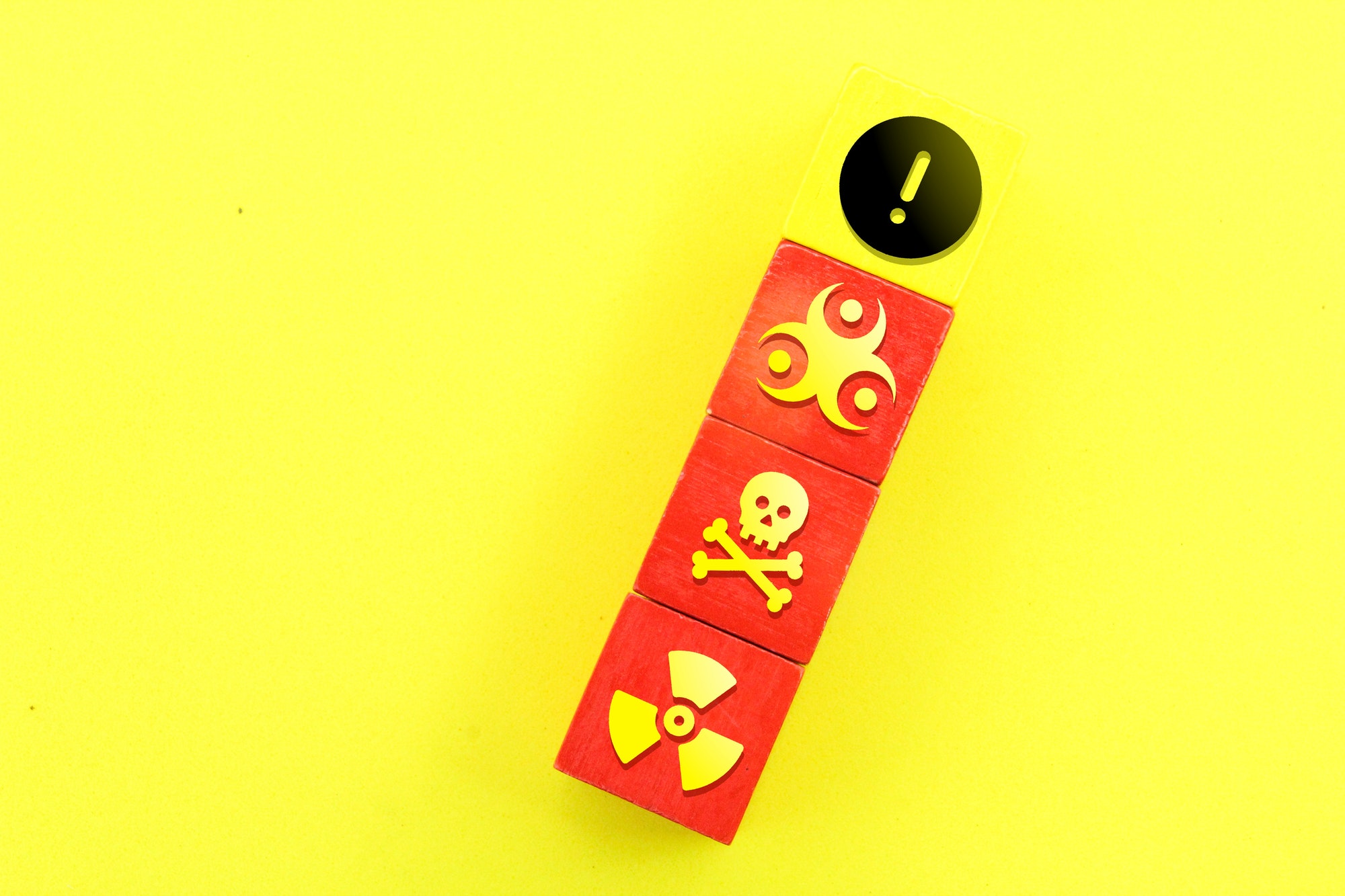 colored cubes with toxic or chemical icons and caution