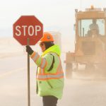 A flagger controls traffic on a Montana highway rebuild project.